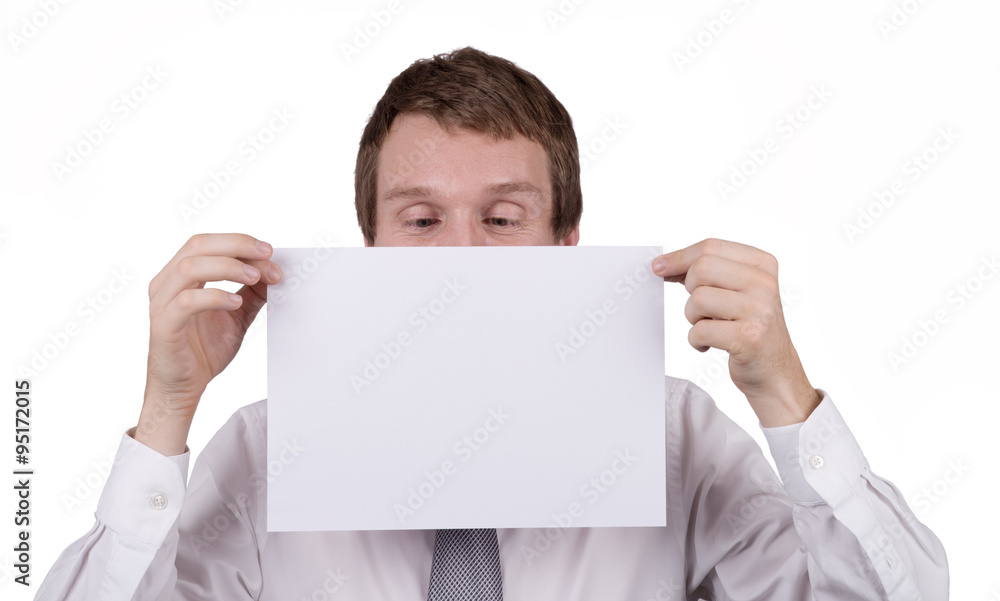 A caucasian male office worker holding a blank piece of paper in front of himself, looking down at the page where a message can be inserted. Isolated on white. A caucasian male office worker holding a blank piece of paper in front of himself, looking down at the page where a message can be inserted. Isolated on white.