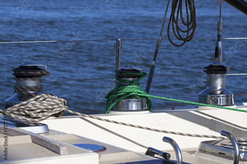 Three modern winches and rope on a sailboat. © mauvries