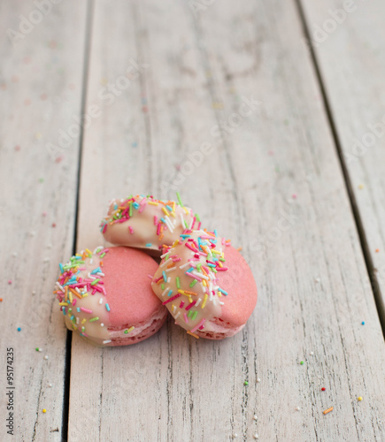 Chocolate Dipped Pink Macaroons with Berries Buttercream and Sprinkles