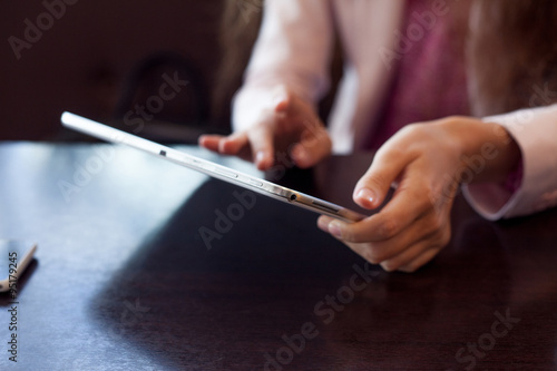 girl works on the digital tablet, a small depth of field, soft focus