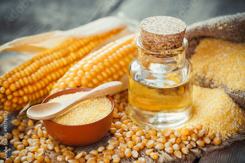 Corn essential oil bottle, corn groats, dry seeds and corncobs o