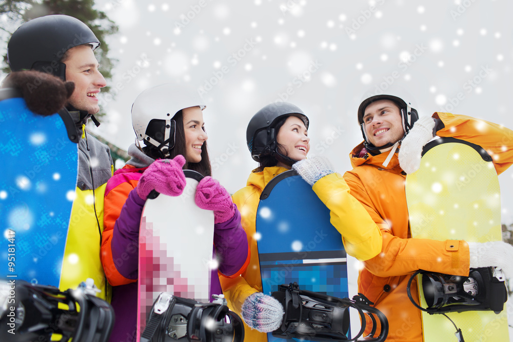 happy friends in helmets with snowboards talking happy friends in helmets with snowboards talking