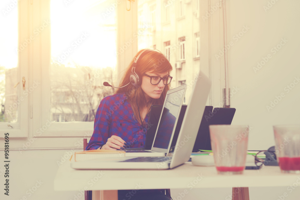 Office girl doing some work on a laptop. Office girl doing some work on a laptop.
