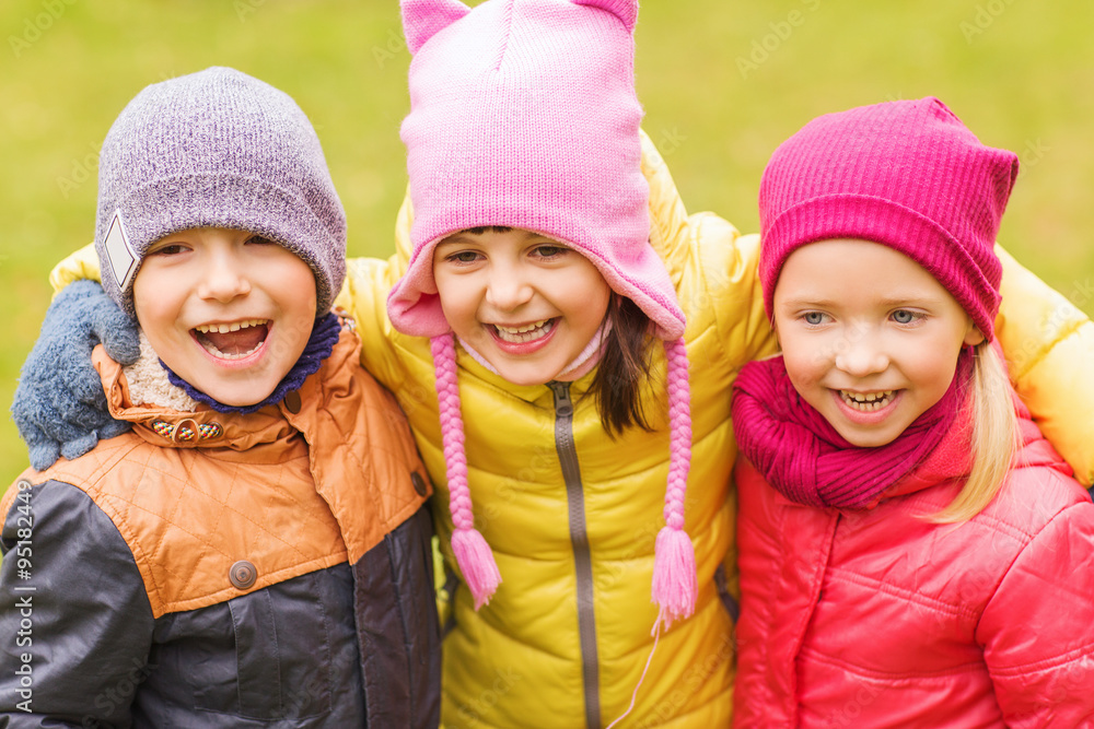 group of happy children hugging in autumn park group of happy children hugging in autumn park