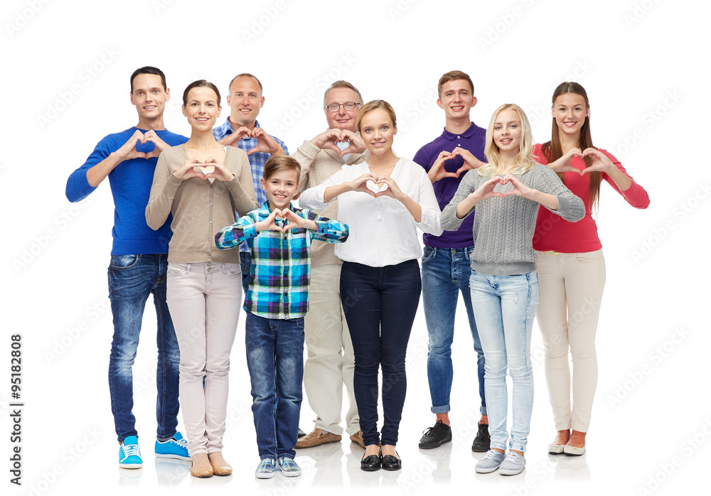 group of smiling people showing heart hand sign