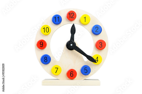 Wooden clock on a white background. Toy for Children