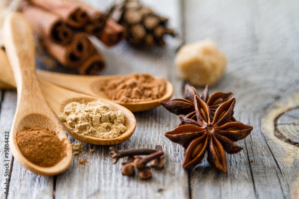 Selection of christmas spices on rustic wood background Selection of christmas spices on rustic wood background
