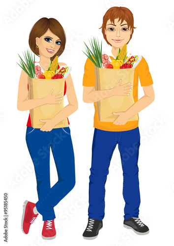 Happy couple carrying grocery paper bags