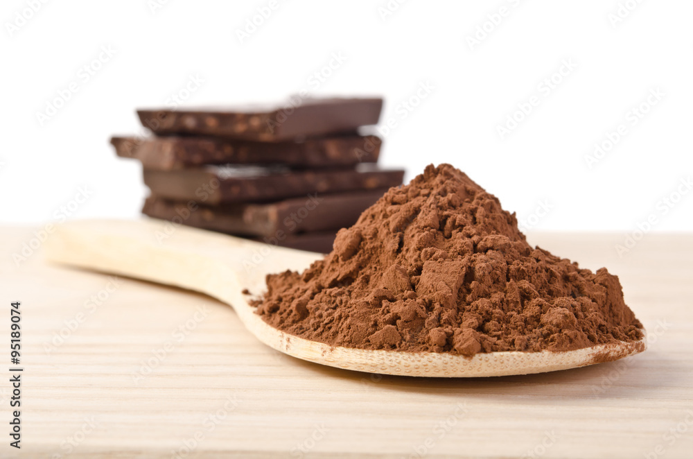 the tower from chocolate with nuts and cacao powder in the wooden spoon the tower from chocolate with nuts and cacao powder in the wooden spoon