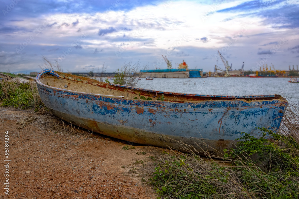 Old derelict boat on pebble beach. Old derelict boat on pebble beach.