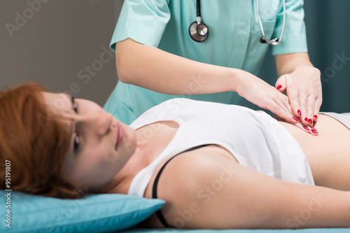 Schilderij op canvas Patient with stomach pain