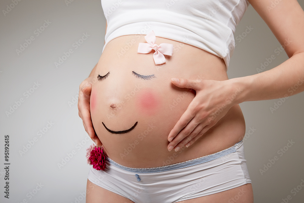 Foto de Pregnant belly painted as a face do Stock | Adobe Stock