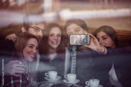 Group Of Friends In Cafe Taking Selfie