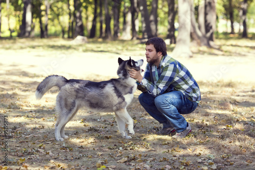 The young man and the Siberian Husky
