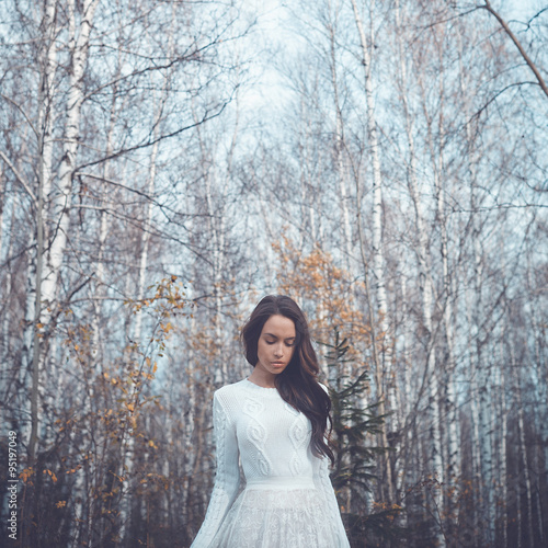 Beautiful lady in a birch forest