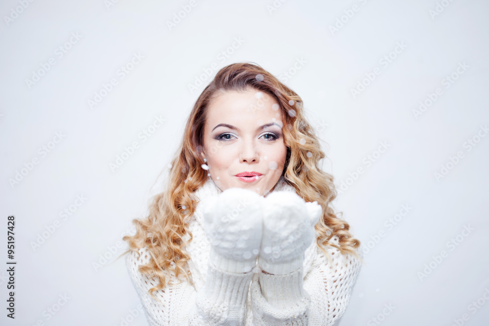 Woman Blowing Snow, girl in warm knitted scarf and gloves, portrait on white background, place for your text Woman Blowing Snow, girl in warm knitted scarf and gloves, portrait on white background, place for your text