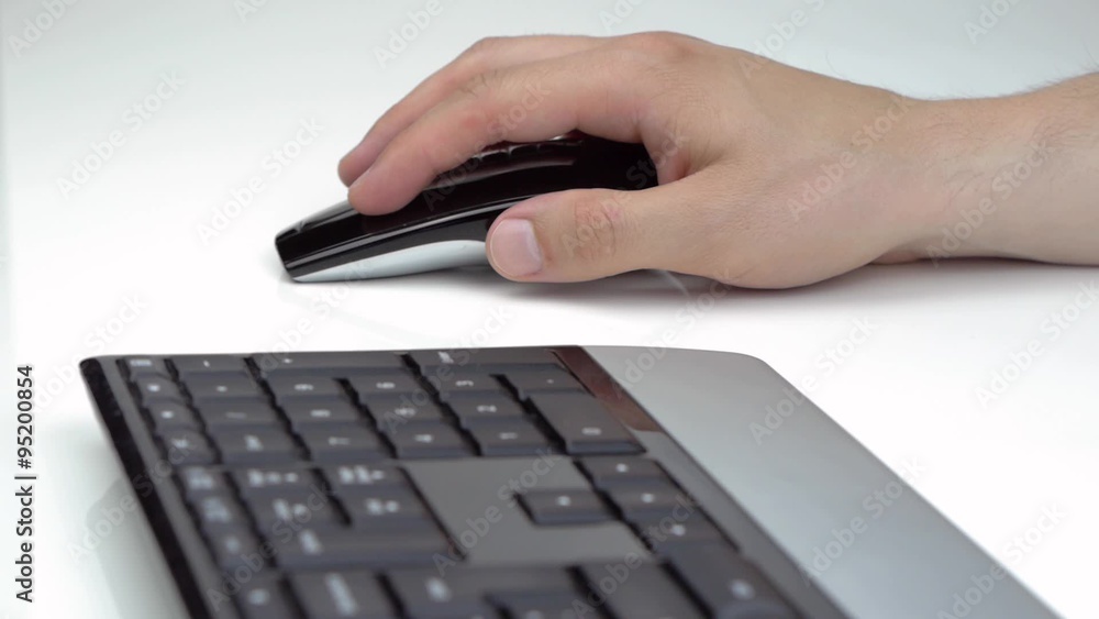 Male hand using a mouse on white table Male hand using a mouse on white table