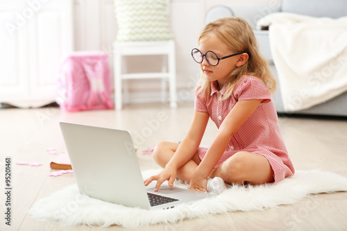 Little girl with laptop in ...