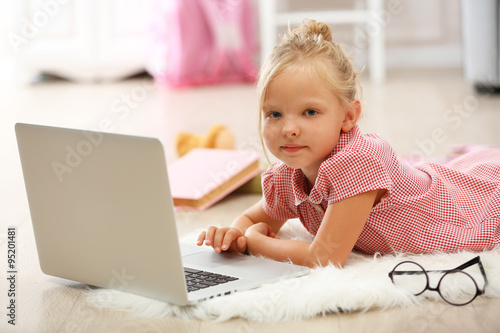 Little girl with laptop in ...