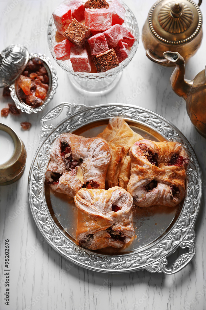 Antique tea-set with Turkish delight and baking on table close-up Antique tea-set with Turkish delight and baking on table close-up