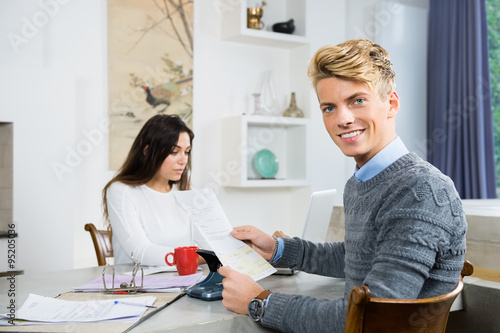 Couple Calculating Personal Finance At Home