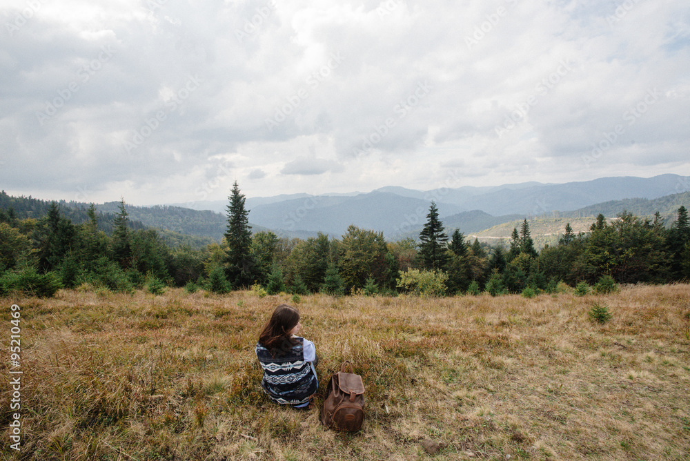 beautiful happy stylish traveling girl sitting in the mountains beautiful happy stylish traveling girl sitting in the mountains