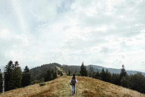 beautiful happy stylish traveling girl in the mountains on a bac