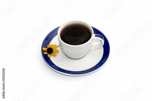 cup of coffee on a saucer with a blue border and a floret  isola