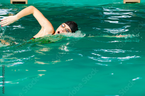 Swimming woman in pool. © Voyagerix