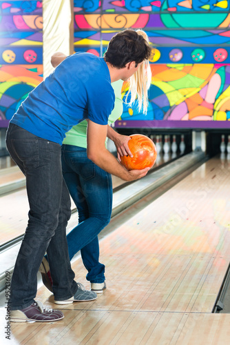 Young people playing bowling and having fun photo