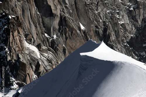 Steep snow dunes on top of mountain in Mont Blanc massif in Chamonix, France