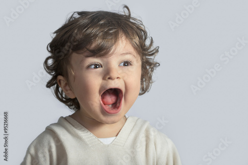 Beautiful baby happily screaming photo
