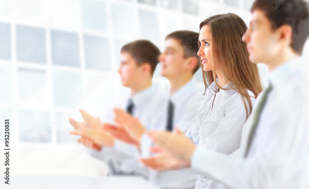 Happy business group applauding at the office