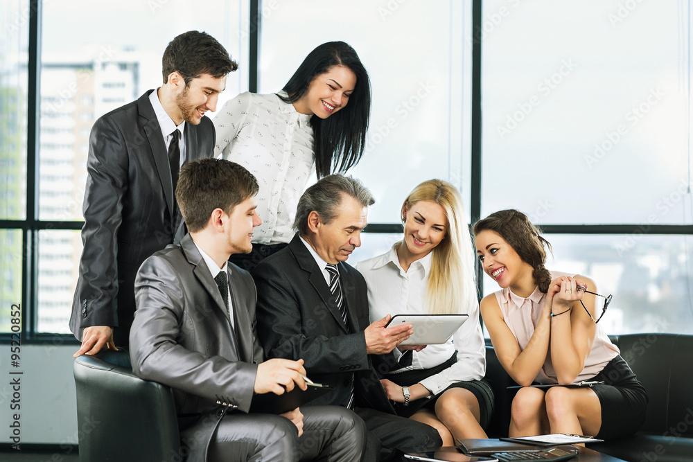 A group of businessmen discussing the policy of the company in t
