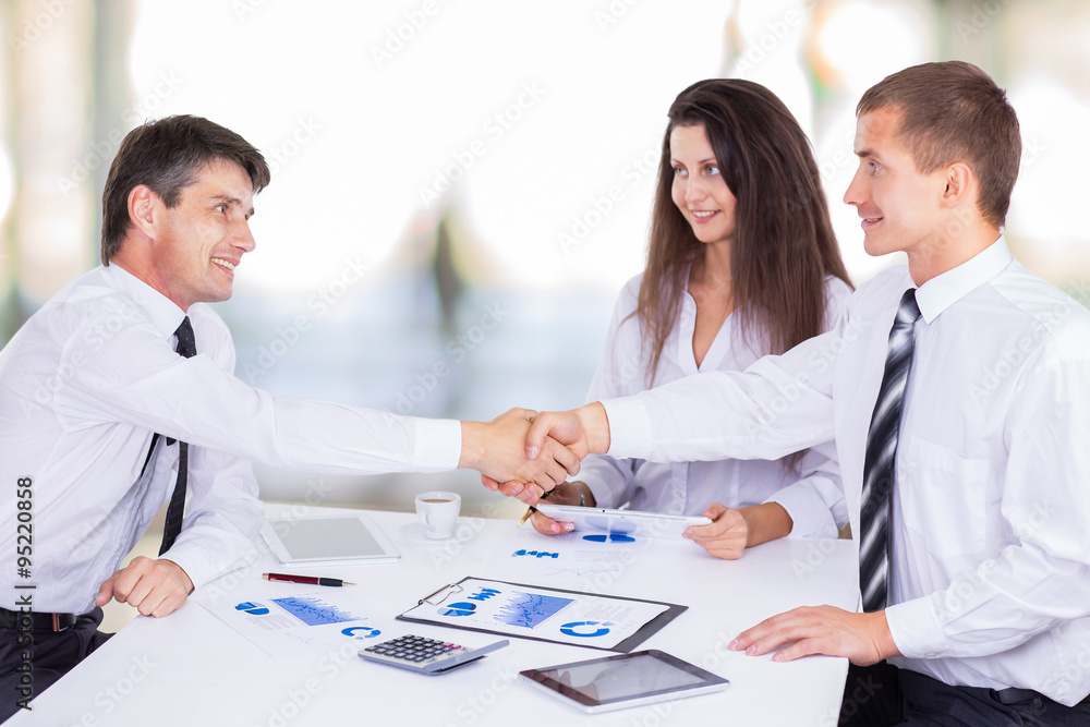 A group of successful businessmen. Discussion of charts A group of successful businessmen. Discussion of charts