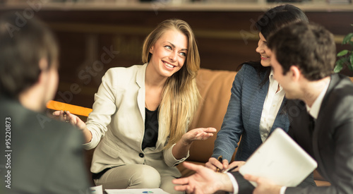 Billede på lærred A group of successful businessmen. Discussion of the important c