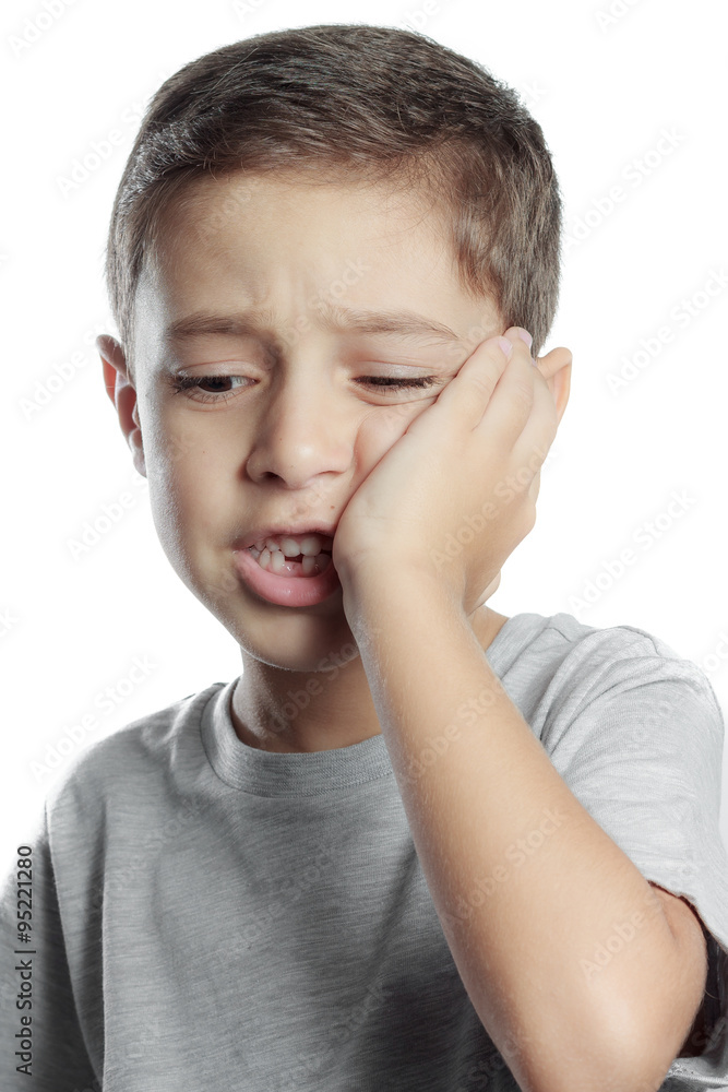 sad little boy suffering from toothache pain in mouth, holding h sad little boy suffering from toothache pain in mouth, holding h