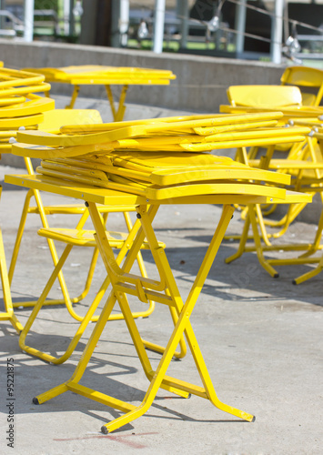 Yellow fold tables and chairs.