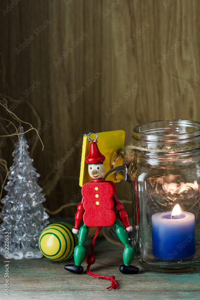 Fototapeta premium Wooden toy soldier in red uniform decoration and candle