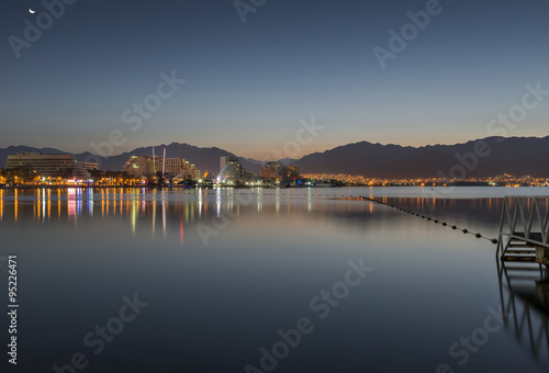 Central beach of Eilat  Israel  at night. Eilat is a famous Israeli city with beautiful sandy beaches  hot sun and clear blue skies  surrounded by stunning mountains and desert scenery