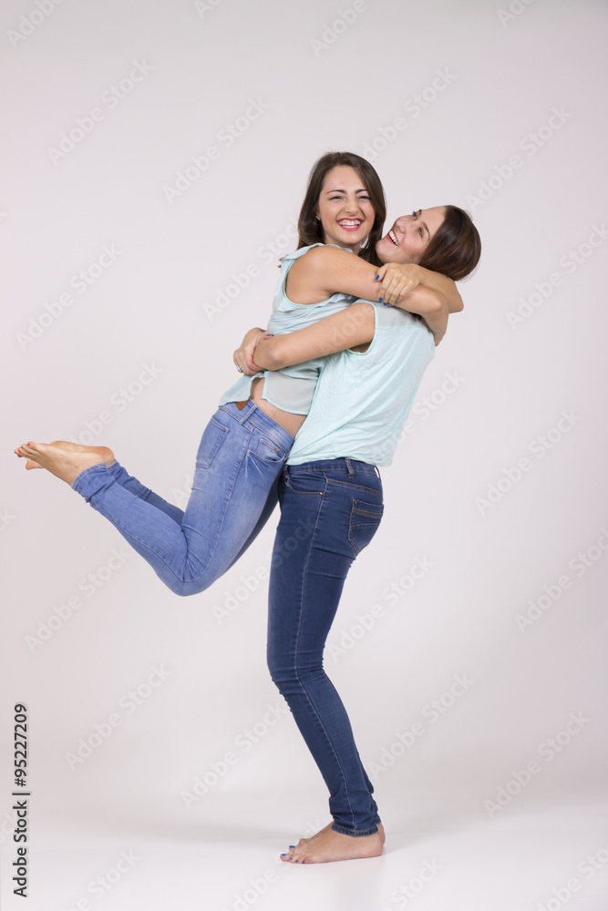 Two lookalike sisters, cute and intimate portrait in studio Two lookalike sisters, cute and intimate portrait in studio