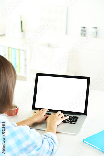 Woman working with laptop in office