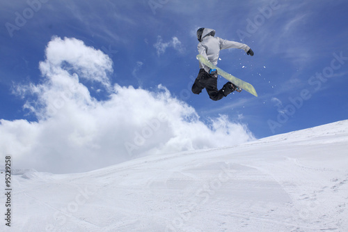 Flying snowboarder on mountains, extreme sport © Vasily Merkushev