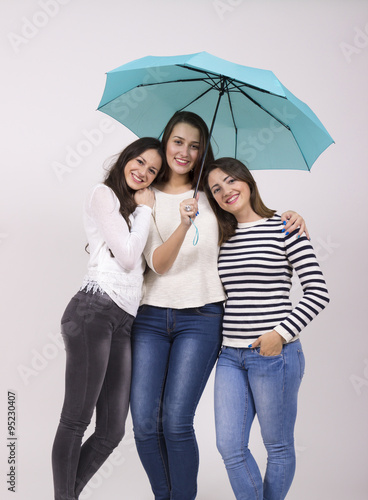 three girls under umbrella