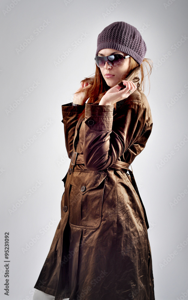 Photo of beautiful woman with hat, sunglasses and coat isolated