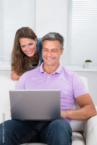 Mature Couple Looking At Laptop