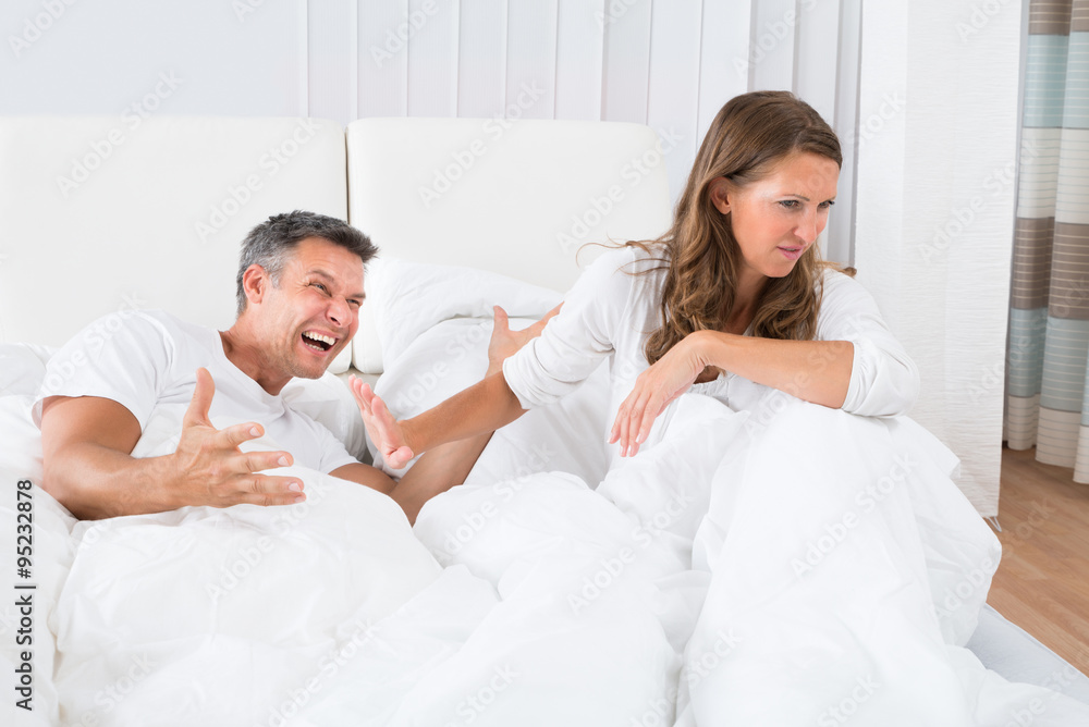 Couple Disputing On Bed Couple Disputing On Bed