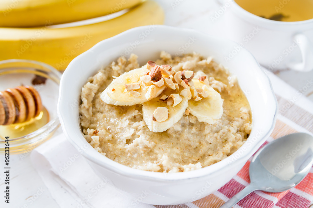 Autumn oatmeal in white bowl banana honey Autumn oatmeal in white bowl banana honey