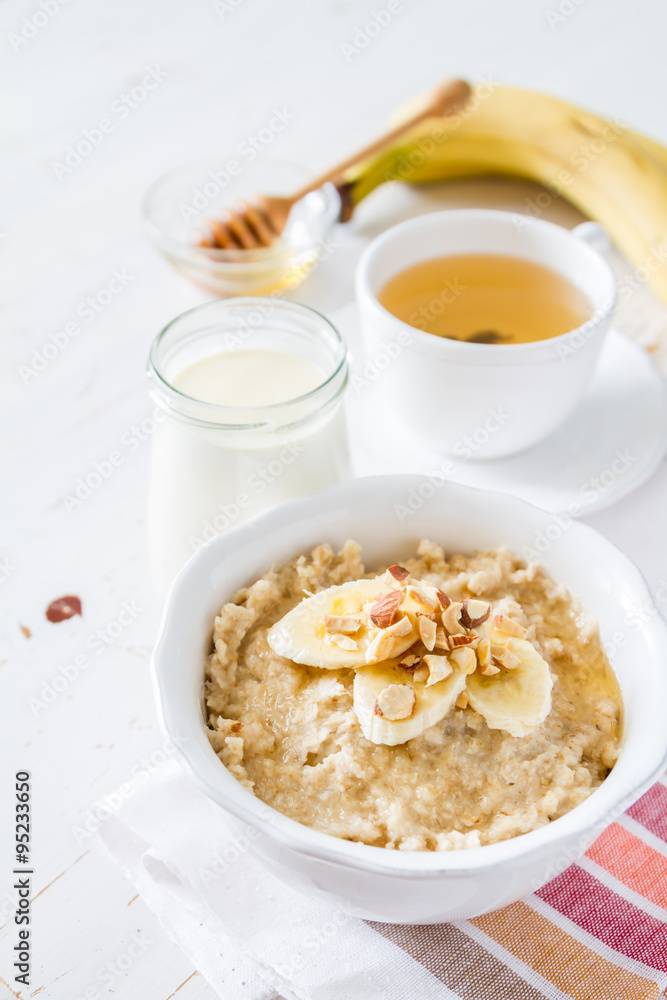 Autumn oatmeal in white bowl banana honey Autumn oatmeal in white bowl banana honey