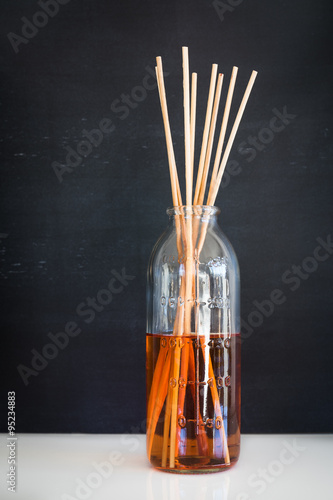 Aroma reed diffuser: sticks in old measuring bottle filled with scent liquid